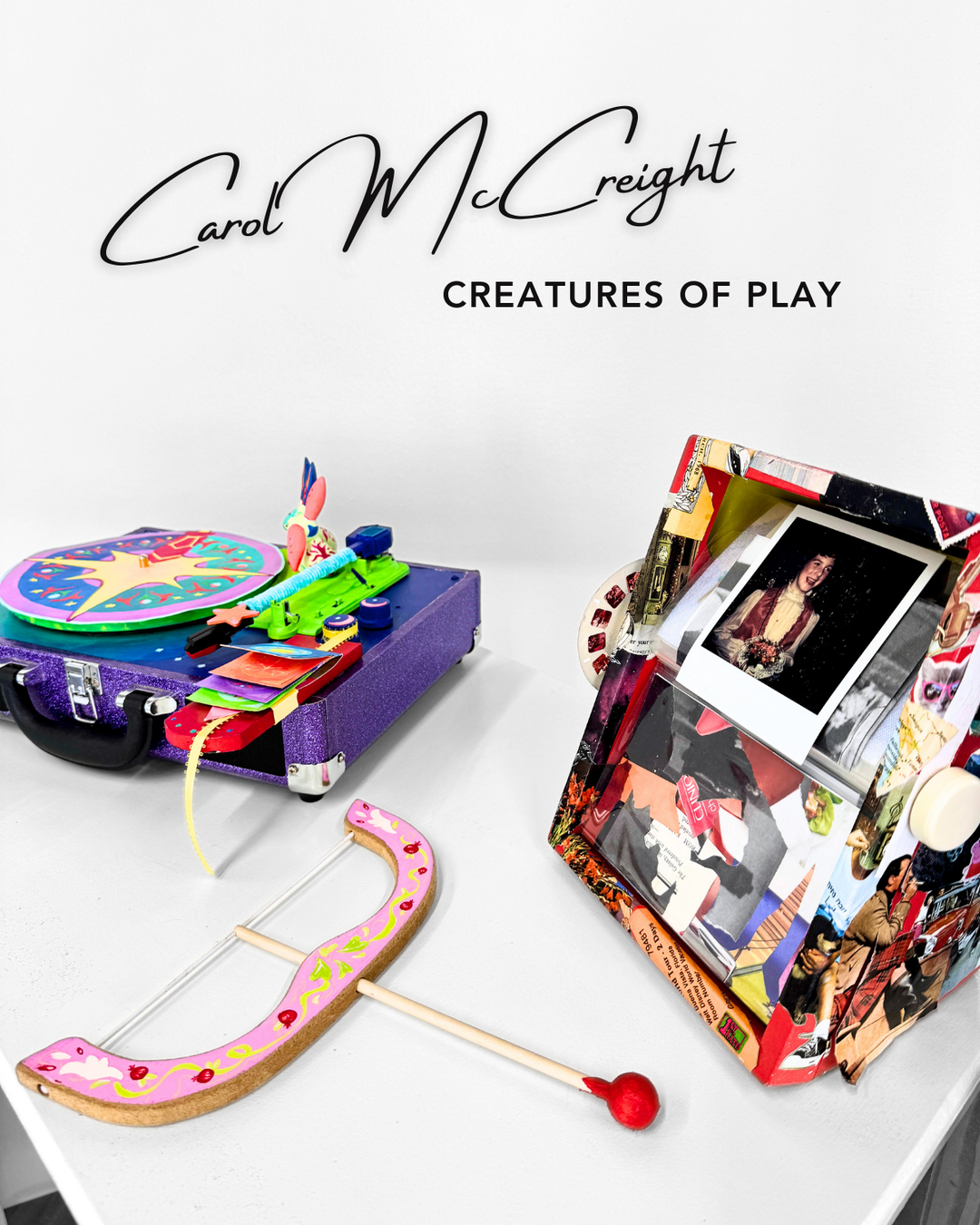 Artwork designed for interaction includes a Colorful toy record player and rolla deck set with a bow and arrow on a white surface, featuring the brand 'Carol McCreight'.