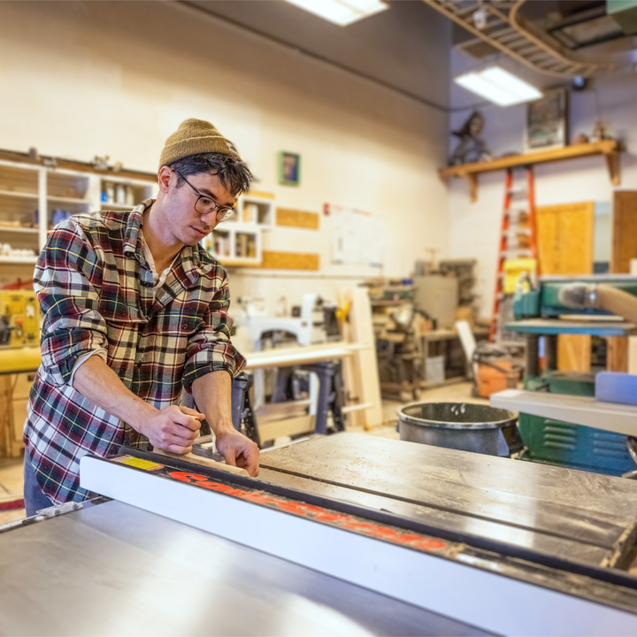 A young man demonstrates new saw safety knowledge at the Innovation Hub during class.